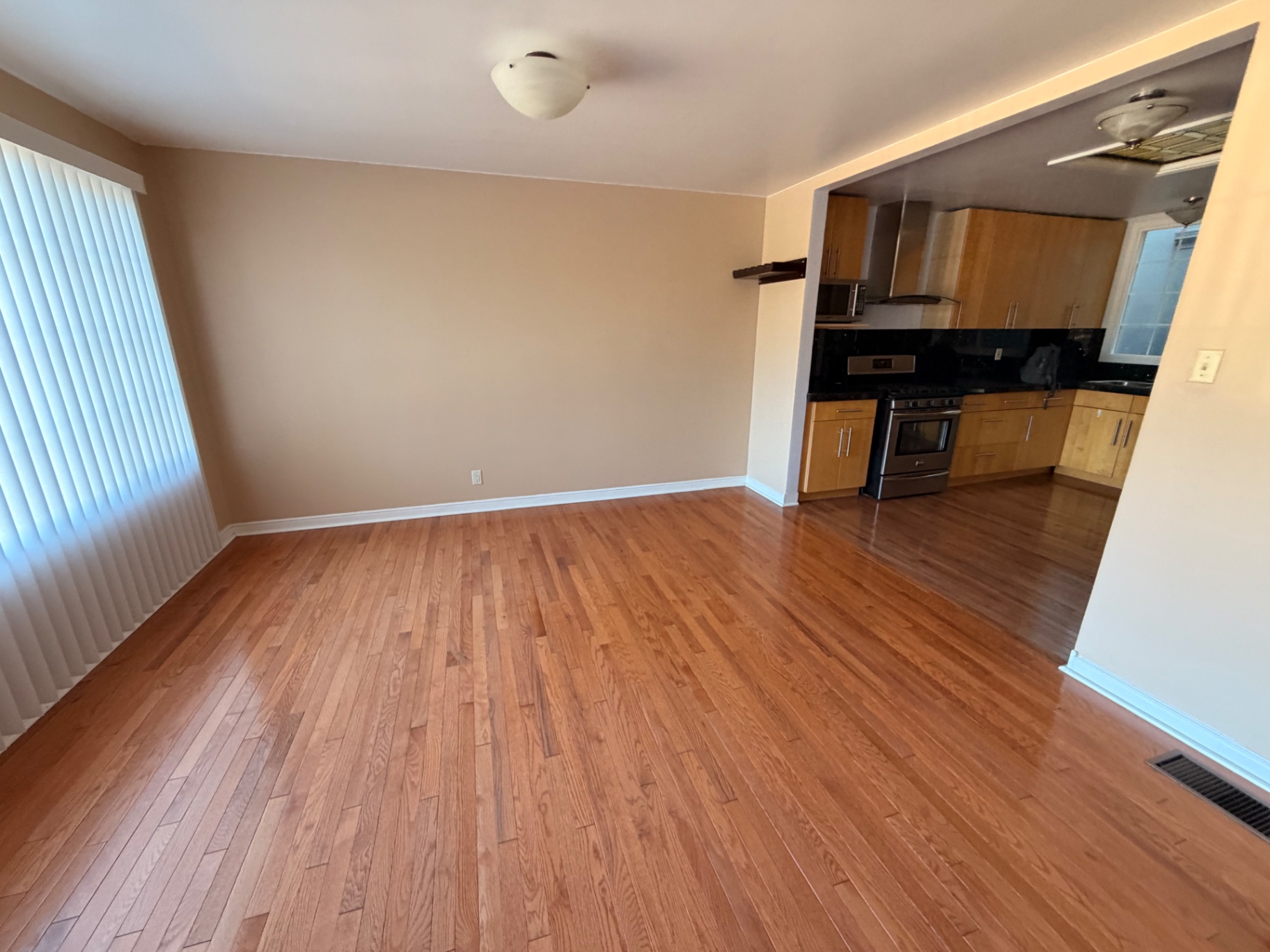 Dining room open to the kitchen with hardwood floors