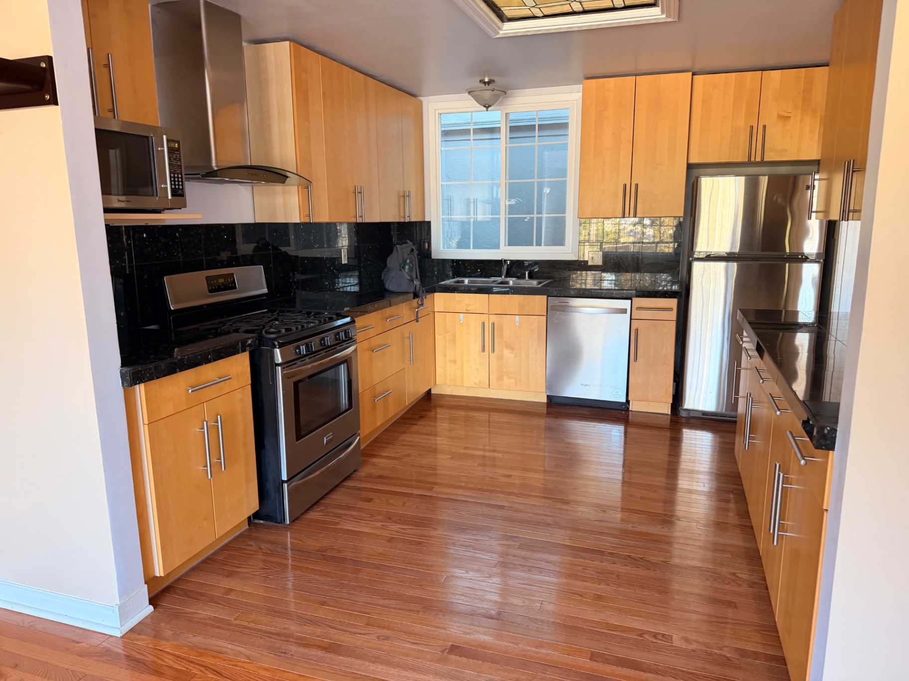 Kitchen with maple cabinets, granite counters, and stainless steel appliances